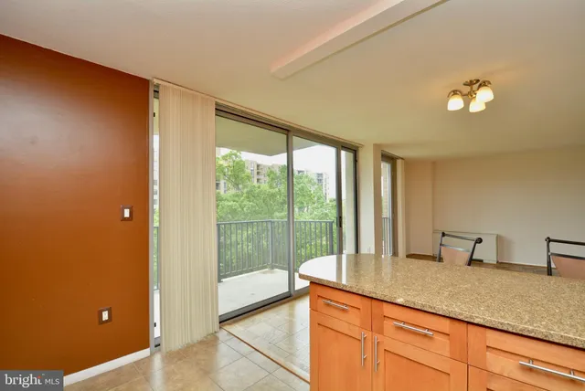 a kitchen with sink and large window
