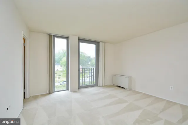 a view of empty room with floor to ceiling window