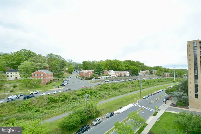 a view of a city street with a yard