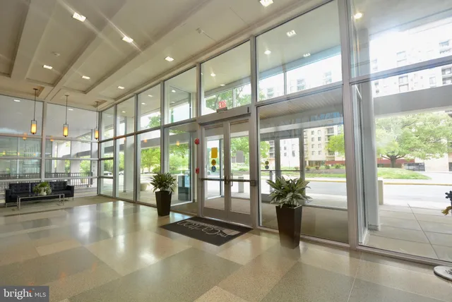 a lobby with furniture and large windows