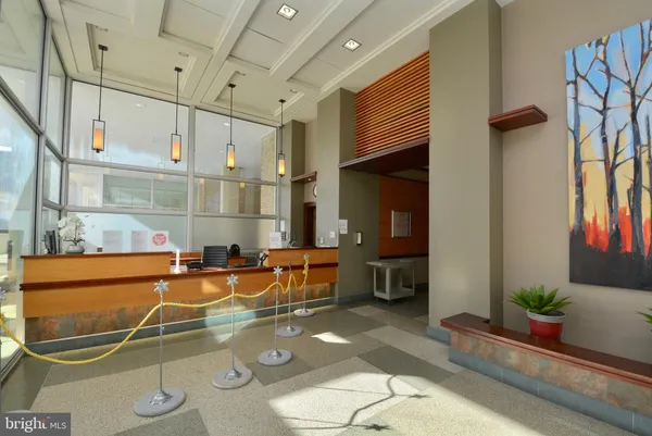 a room with table chairs and potted plants