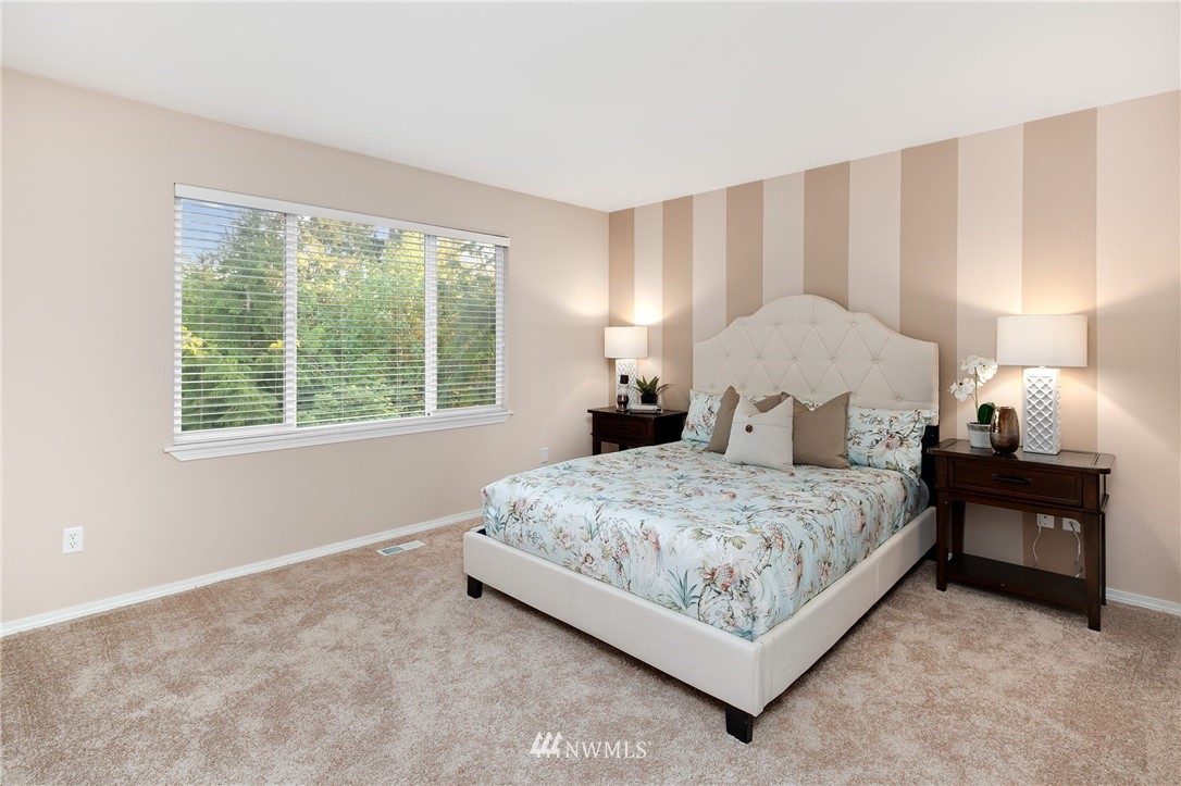 2522 Stafford Way Bothell, WA 98012 - Photo 11 of 23 a bedroom with a bed lamp and a large window
