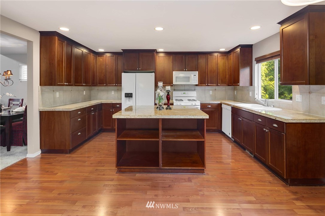 2522 Stafford Way Bothell, WA 98012 - Photo 6 of 23 a kitchen with kitchen island granite countertop a sink counter top space and cabinets