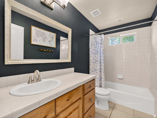 557 Craftsman Way Midway, UT 84049 - Photo 38 of 59 Bathroom featuring a wood-finish vanity with a tile countertop, an undermount sink, and a framed mirror