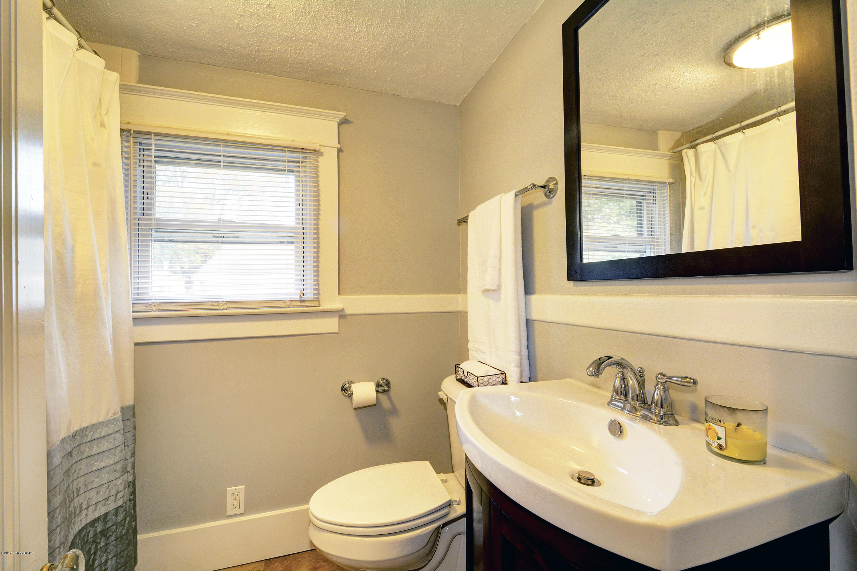 217 Iola Road Louisville, KY 40207 - Photo 21 of 44 The first floor full bathroom features a tub shower combo, custom vanity, and brushed nickel hardware.