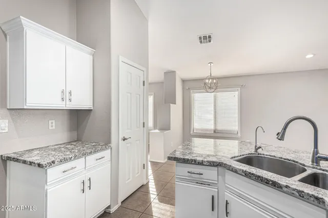 a kitchen with stainless steel appliances granite countertop a sink and cabinets