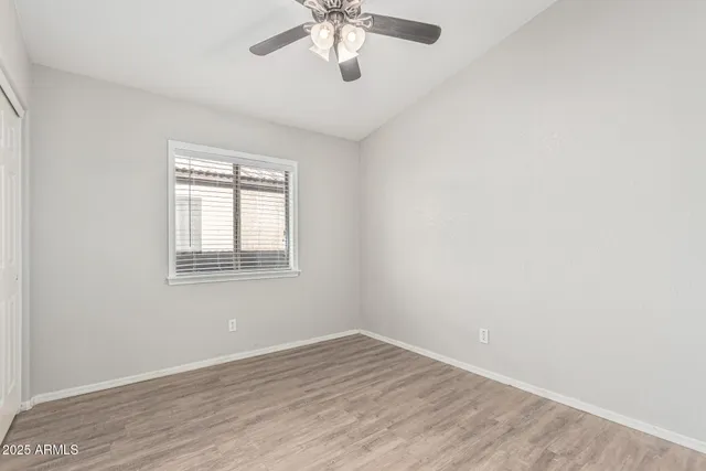 a view of an empty room and wooden floor