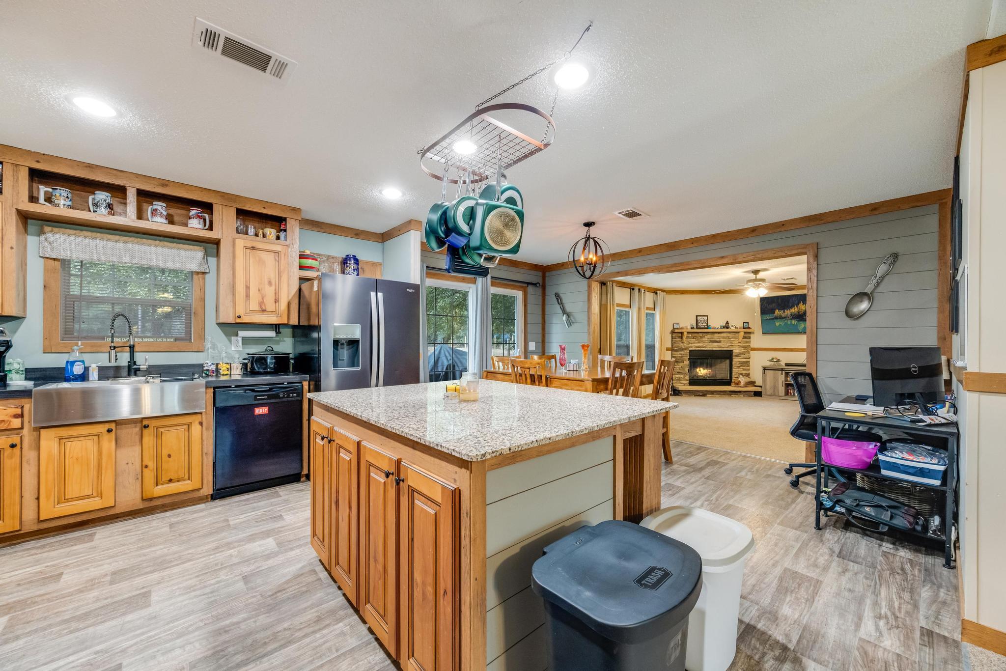 a kitchen with stainless steel appliances granite countertop a stove and a refrigerator