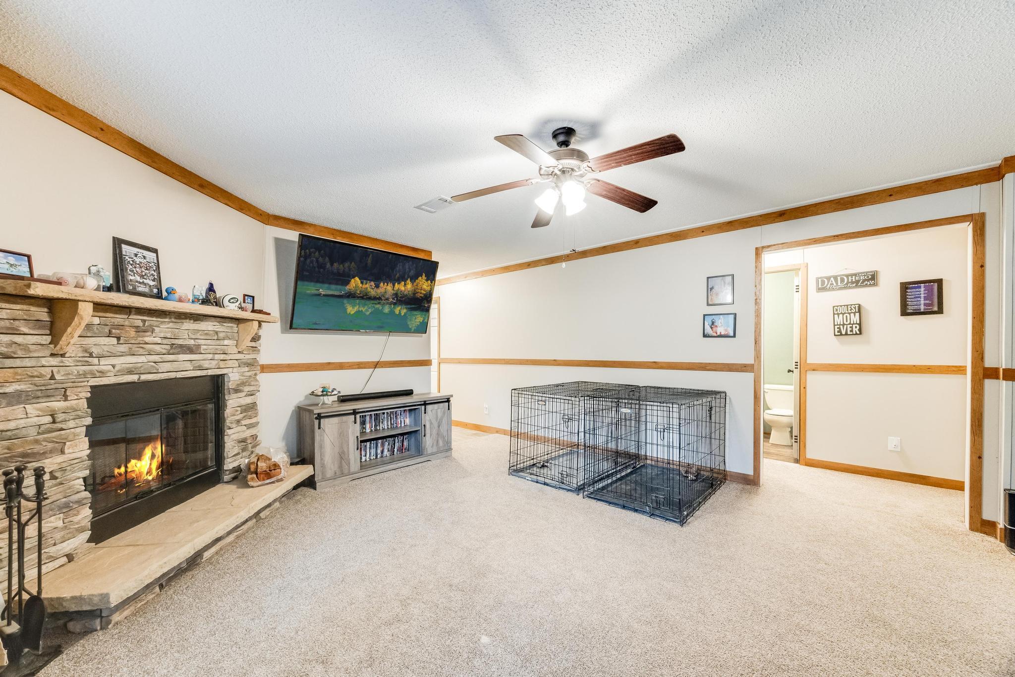 6224 Old River Road Baker, FL 32531 - Photo 15 of 35 a living room with furniture a fireplace and a flat screen tv