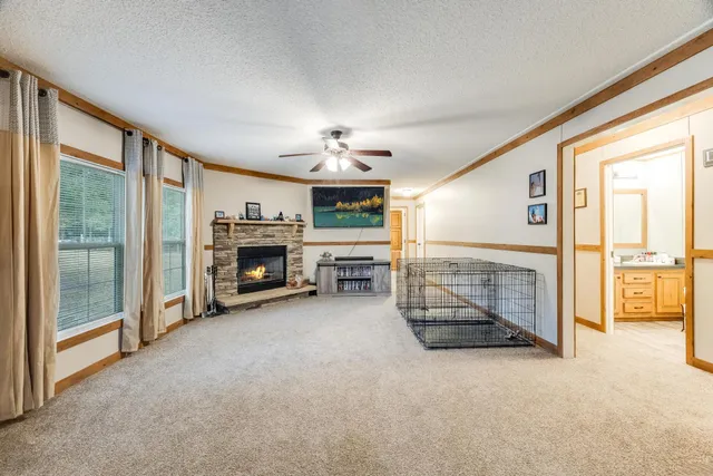 a view of a livingroom with an empty space and a fireplace