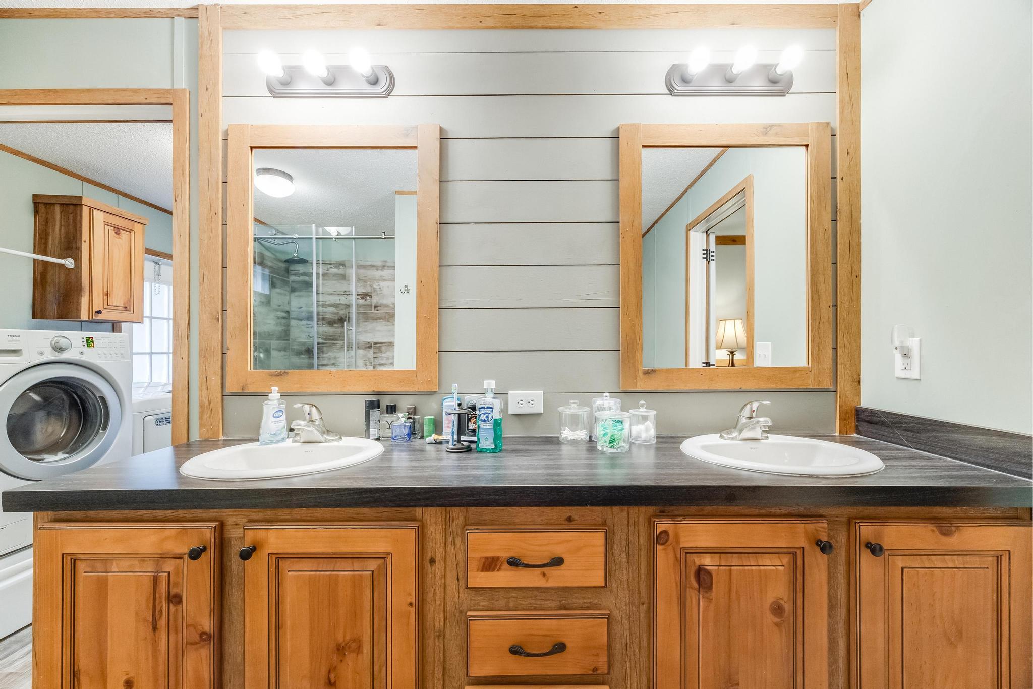 6224 Old River Road Baker, FL 32531 - Photo 19 of 35 a bathroom with a granite countertop sink and a window