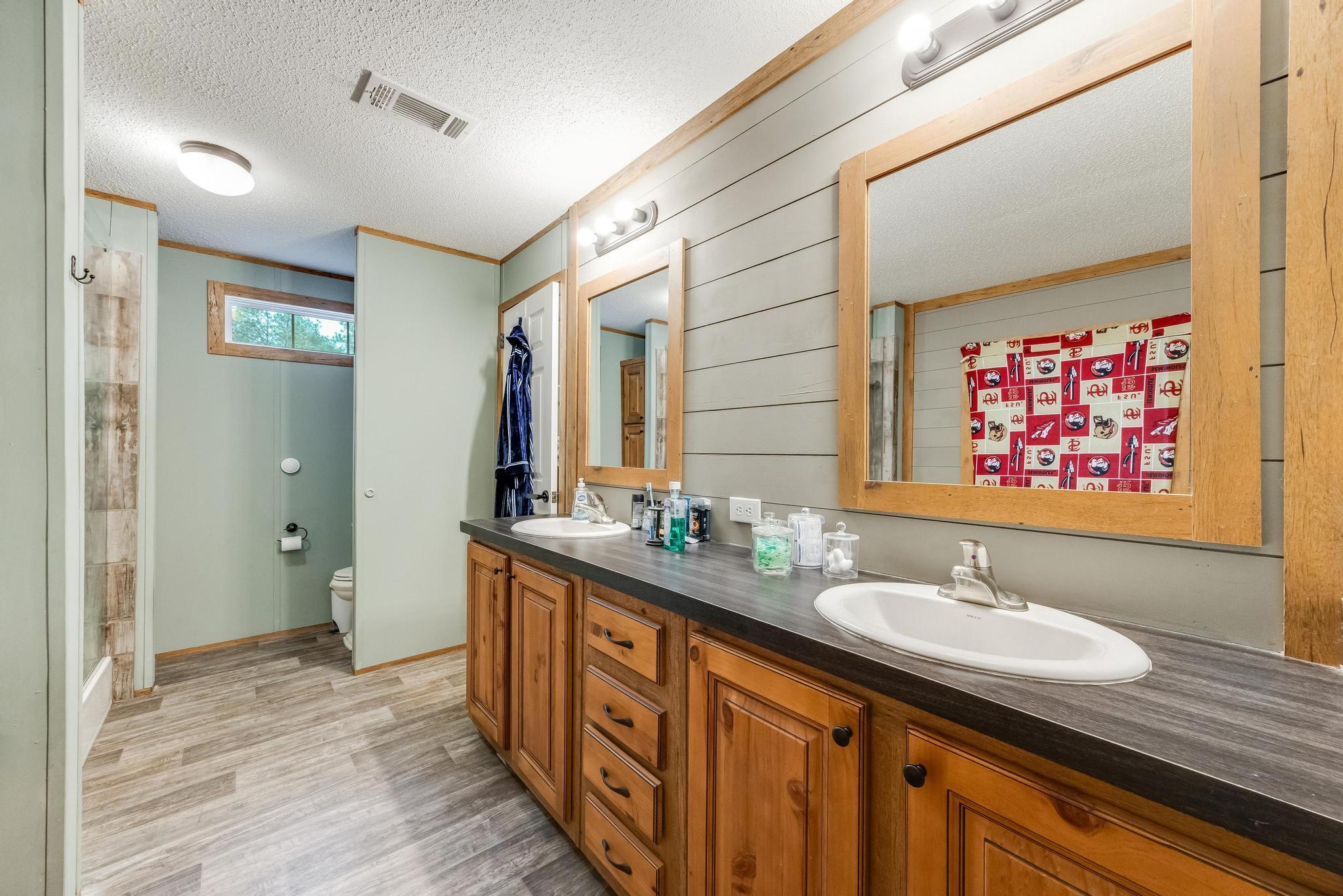 6224 Old River Road Baker, FL 32531 - Photo 20 of 35 a bathroom with a sink double vanity granite and a mirror