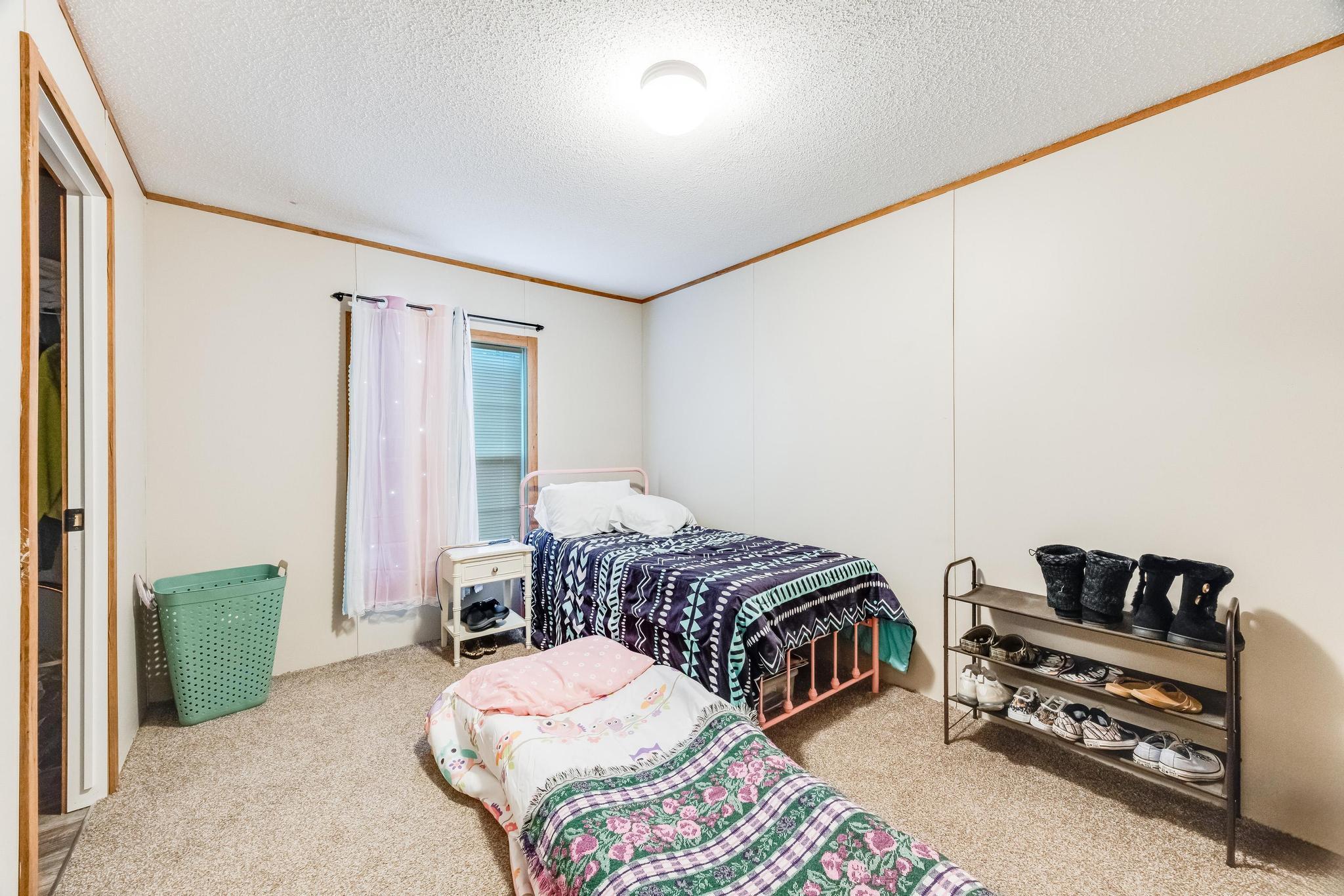 6224 Old River Road Baker, FL 32531 - Photo 22 of 35 a bedroom with bed and a couch