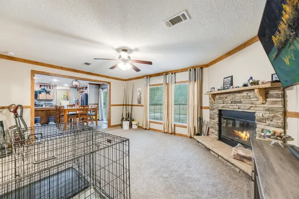 a living room with furniture a fireplace and a flat screen tv
