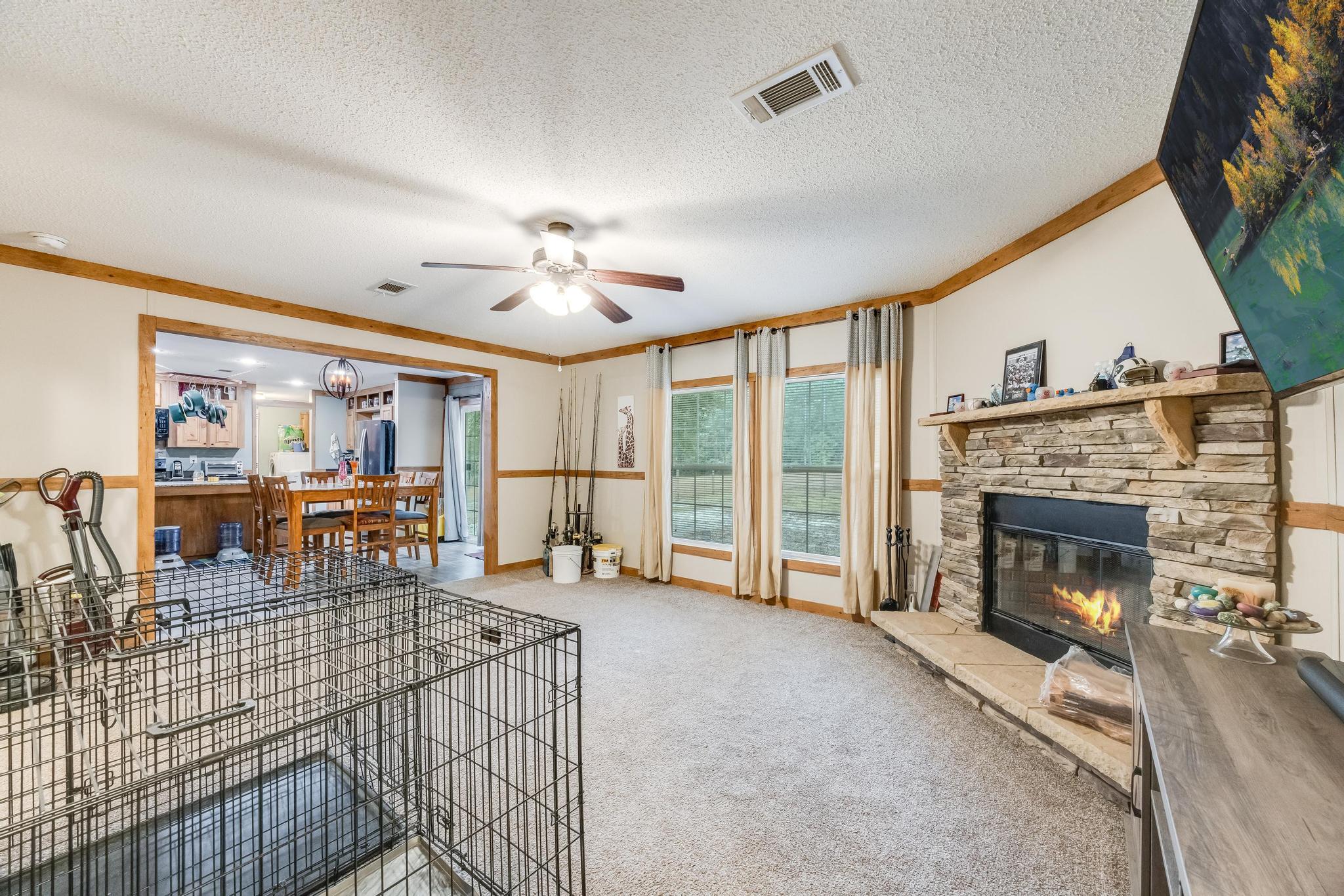 6224 Old River Road Baker, FL 32531 - Photo 23 of 35 a living room with furniture a fireplace and a flat screen tv