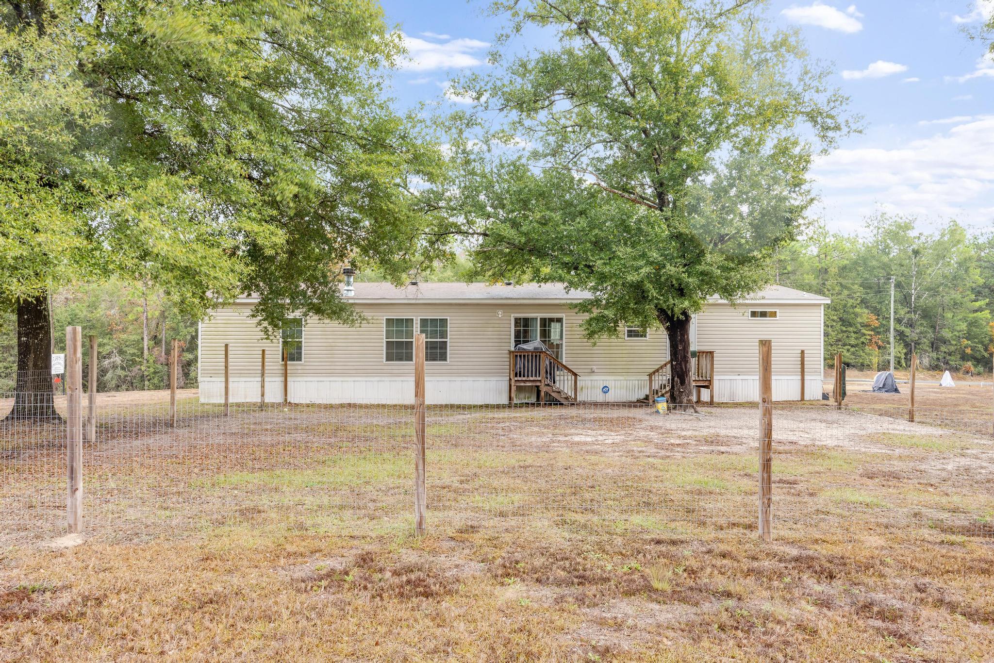 6224 Old River Road Baker, FL 32531 - Photo 27 of 35 a house with trees in the background