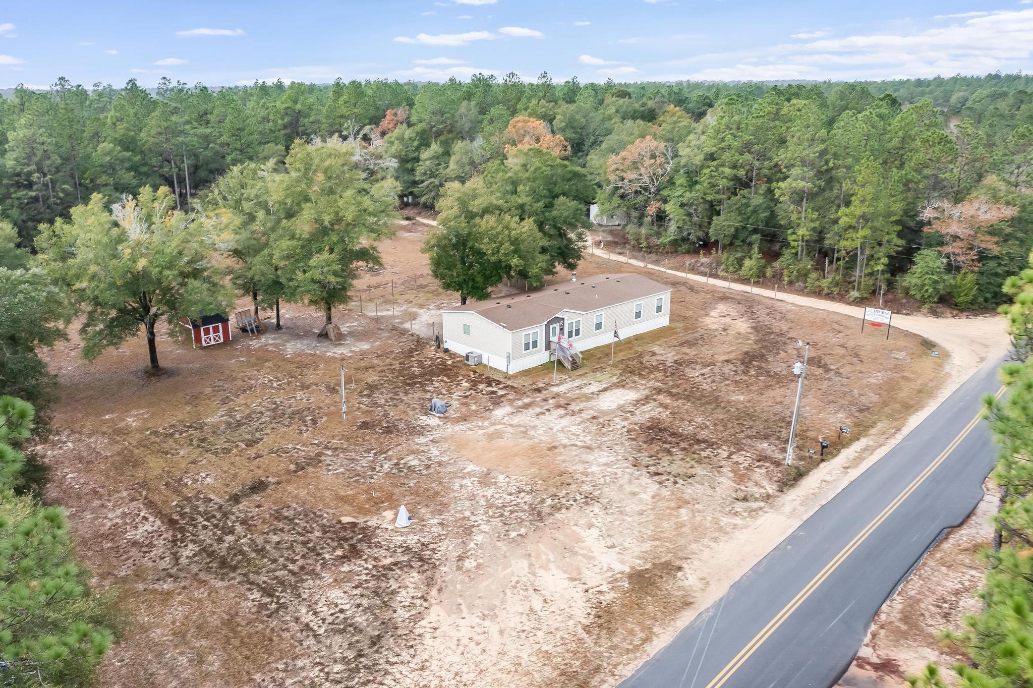 6224 Old River Road Baker, FL 32531 - Photo 31 of 35 a view of a dry yard with large trees