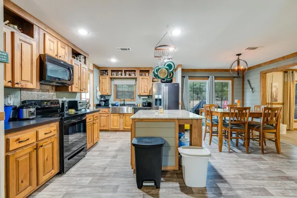 a kitchen with lots of counter top space and appliances