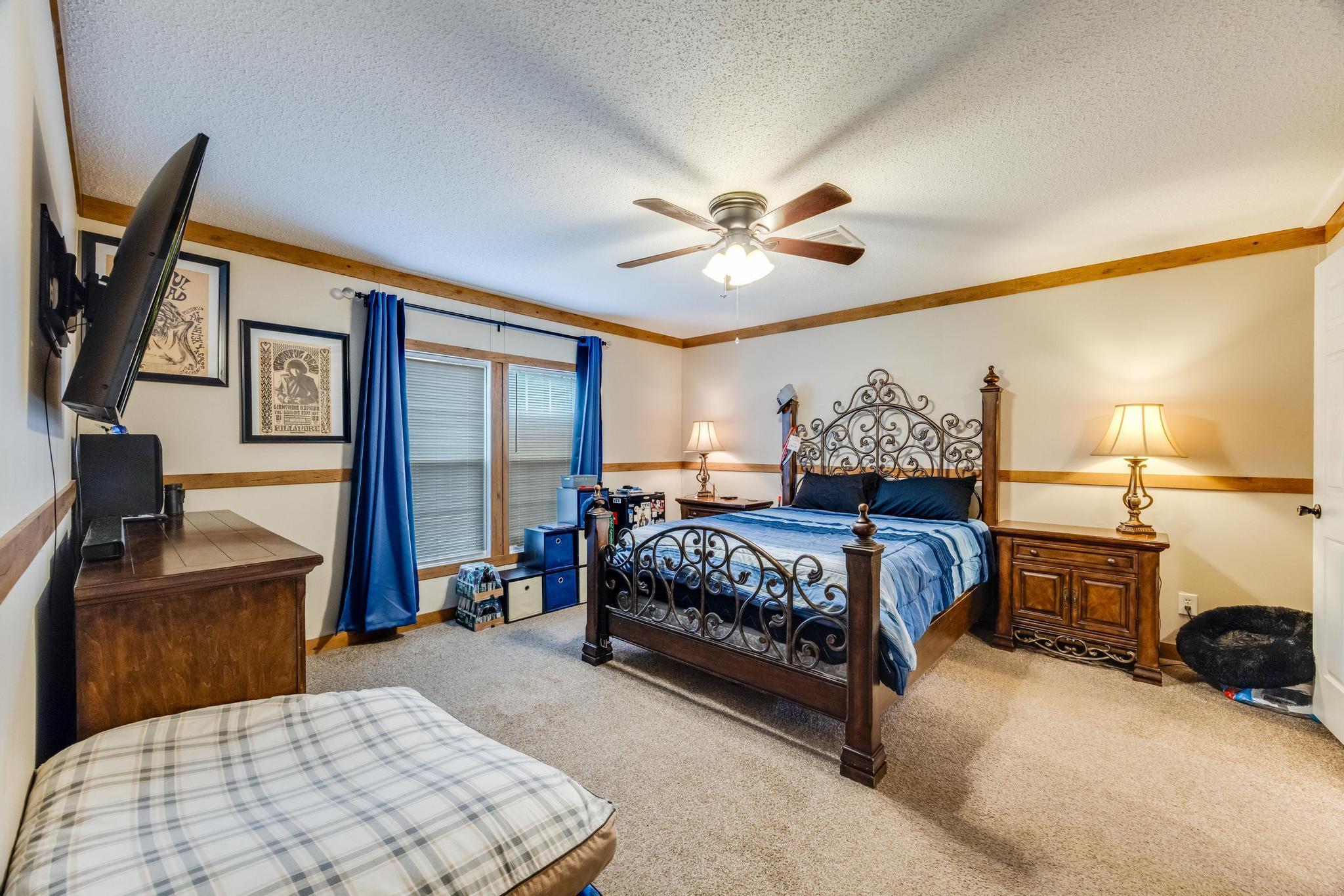 6224 Old River Road Baker, FL 32531 - Photo 9 of 35 a bedroom with a large bed and a chandelier