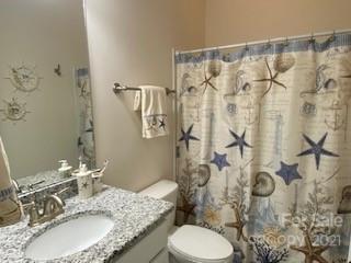 7008 Fallondale Road Waxhaw, NC 28173 - Photo 14 of 29 a bathroom with a granite countertop sink toilet and shower