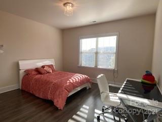 7008 Fallondale Road Waxhaw, NC 28173 - Photo 22 of 29 a bedroom with a bed and wooden floor