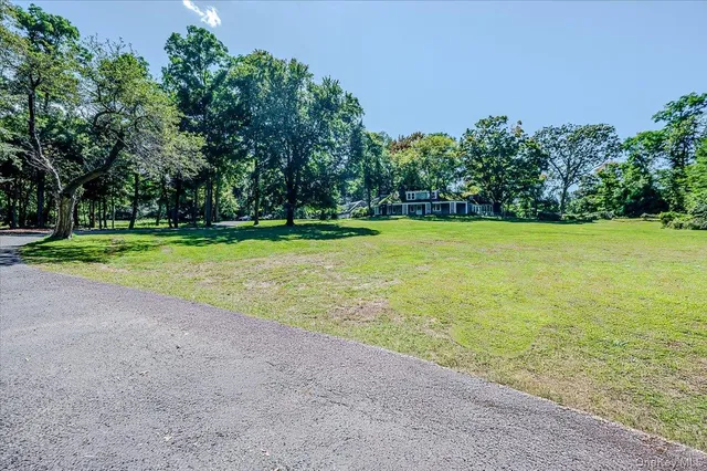 a view of a big yard with large trees