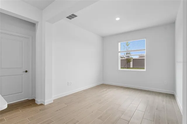 a kitchen with sink and mirror