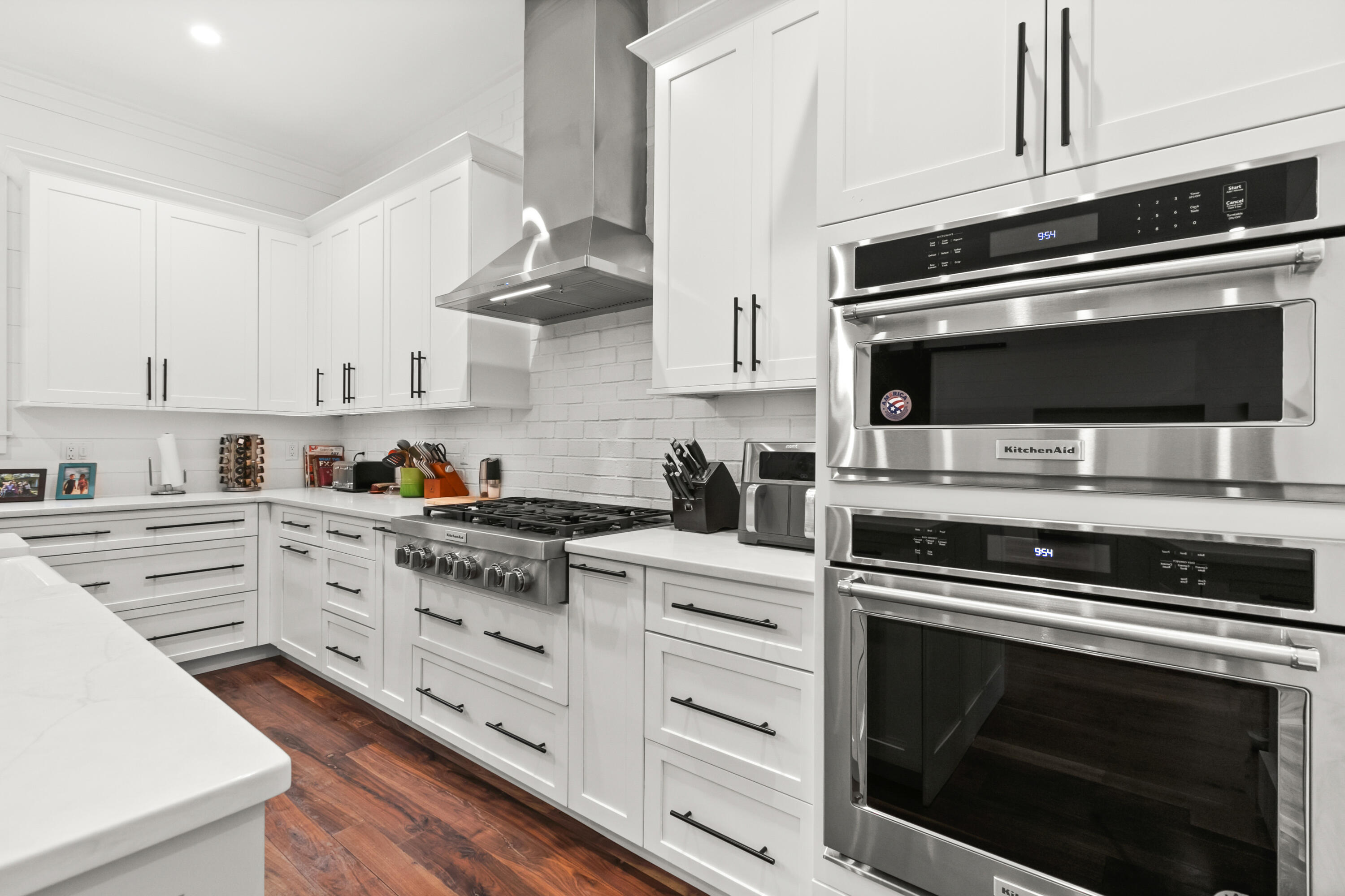 380 Ricker Avenue Santa Rosa Beach, FL 32459 - Photo 11 of 55 a kitchen with granite countertop a stove microwave and cabinets