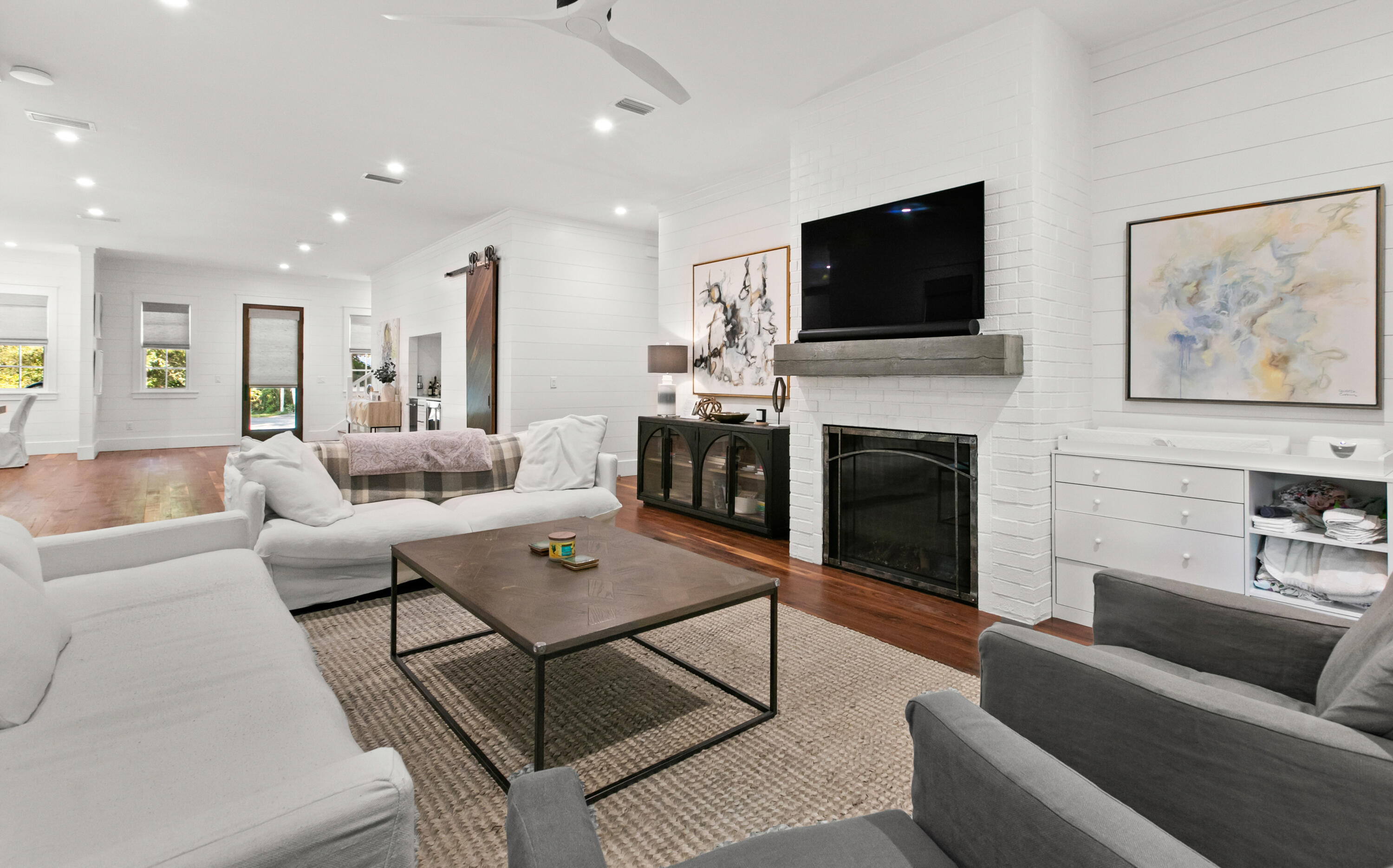 380 Ricker Avenue Santa Rosa Beach, FL 32459 - Photo 17 of 55 a living room with furniture a flat screen tv and a fireplace