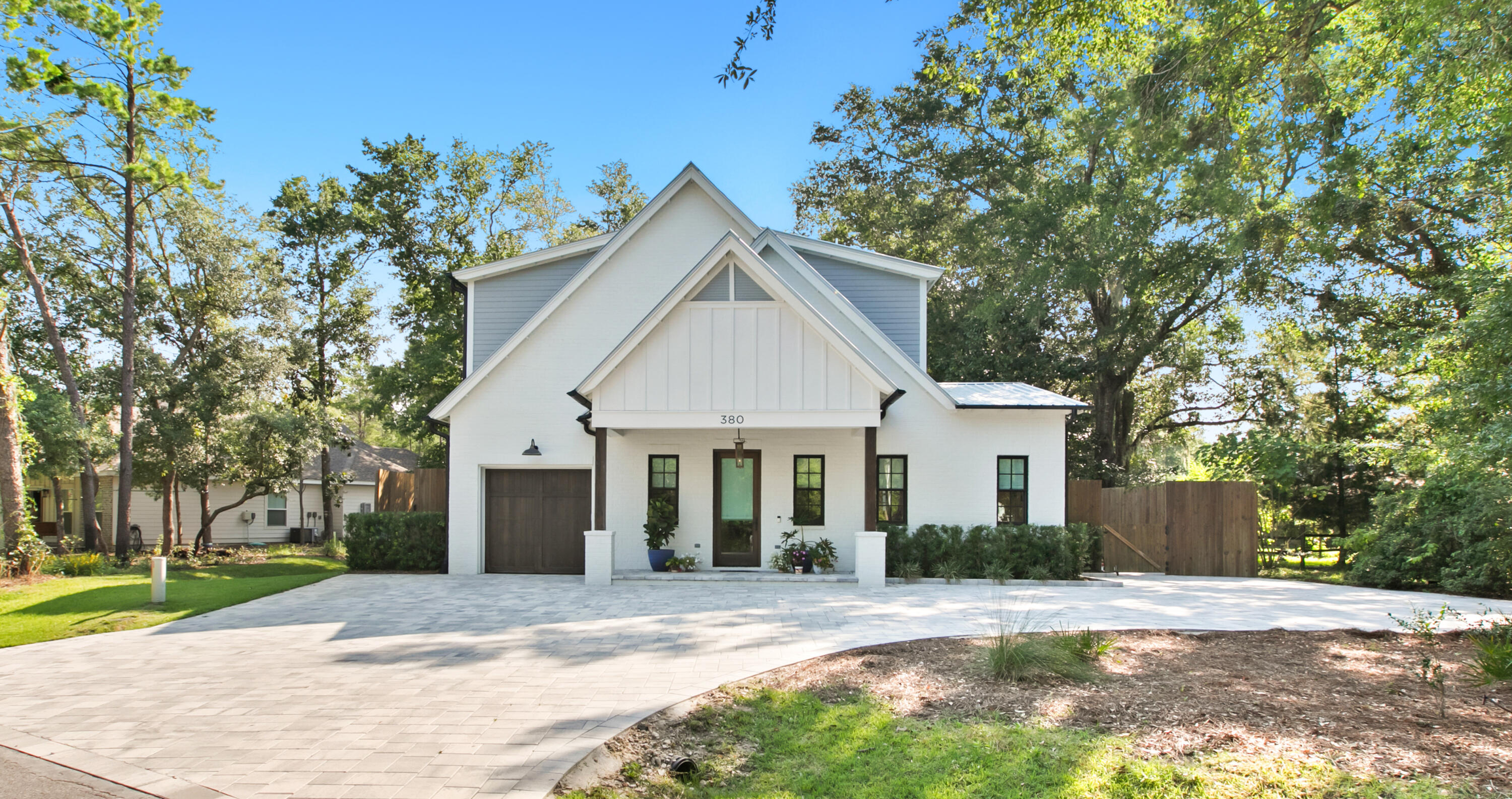 380 Ricker Avenue Santa Rosa Beach, FL 32459 - Photo 2 of 55 a view of a yard in front of a house with large tree