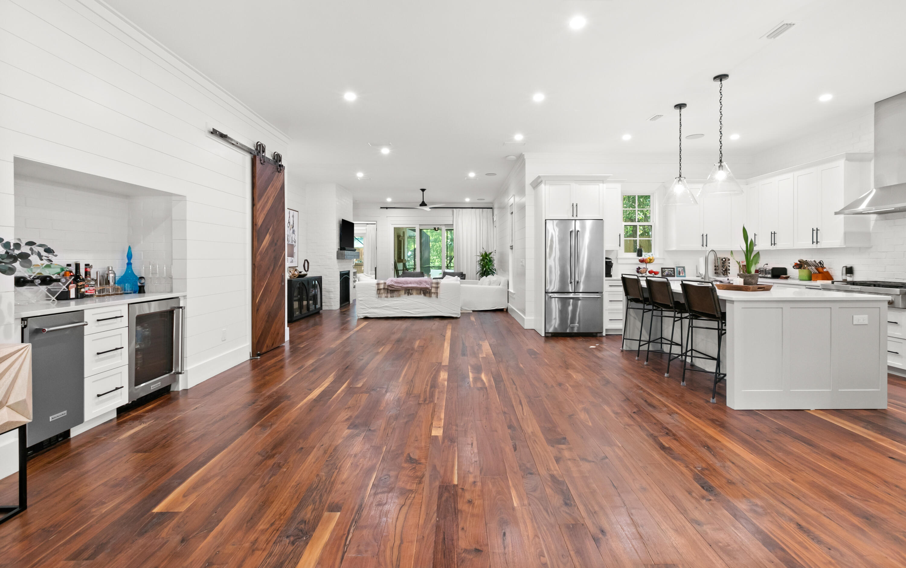 380 Ricker Avenue Santa Rosa Beach, FL 32459 - Photo 5 of 55 a open kitchen with stainless steel appliances granite countertop a refrigerator a oven a stove and white cabinets with wooden floors