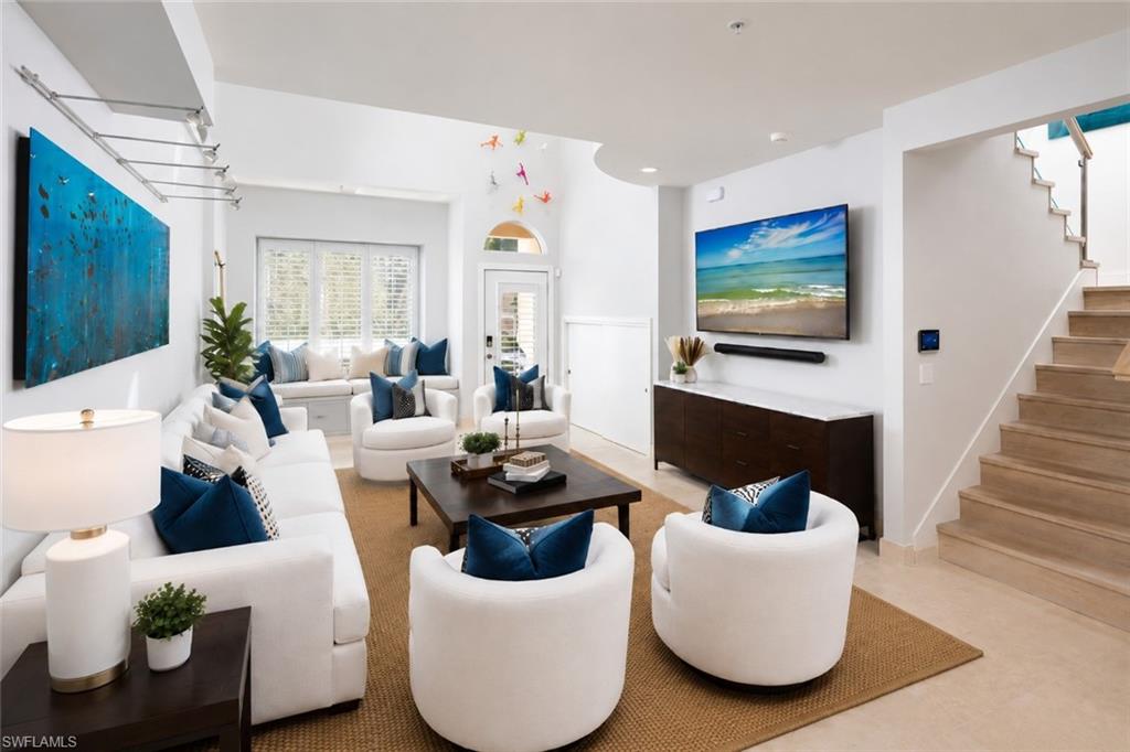 1070 5th Street South Naples, FL 34102 - Photo 2 of 19 a living room with furniture and a flat screen tv
