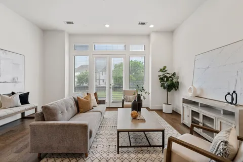 a living room with furniture and a potted plant