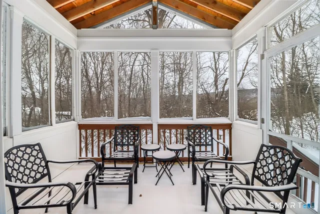 a view of a chairs and table in the balcony