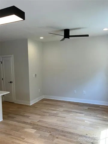 a view of a room with an empty space & a window