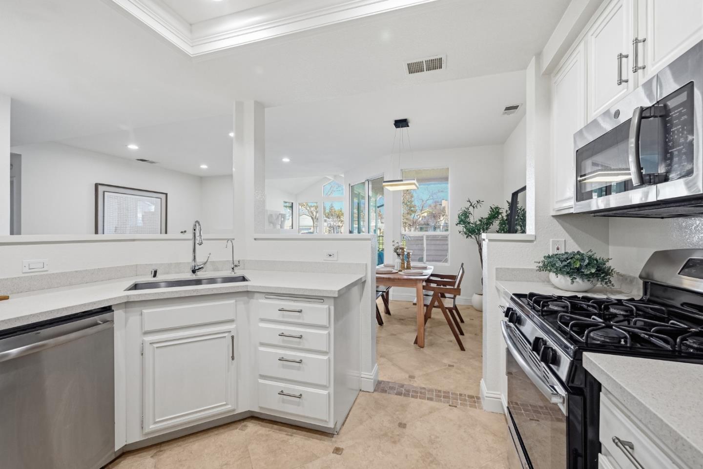 34590 Falls Terrace Fremont, CA 94555 - Photo 12 of 38 a kitchen with a sink stove and cabinets