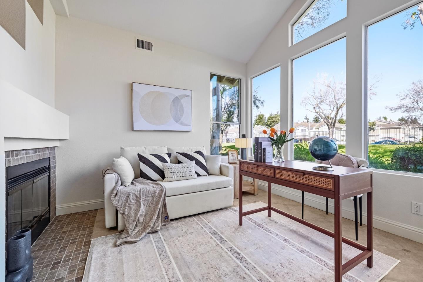 34590 Falls Terrace Fremont, CA 94555 - Photo 15 of 38 a living room with furniture a fireplace and a floor to ceiling window