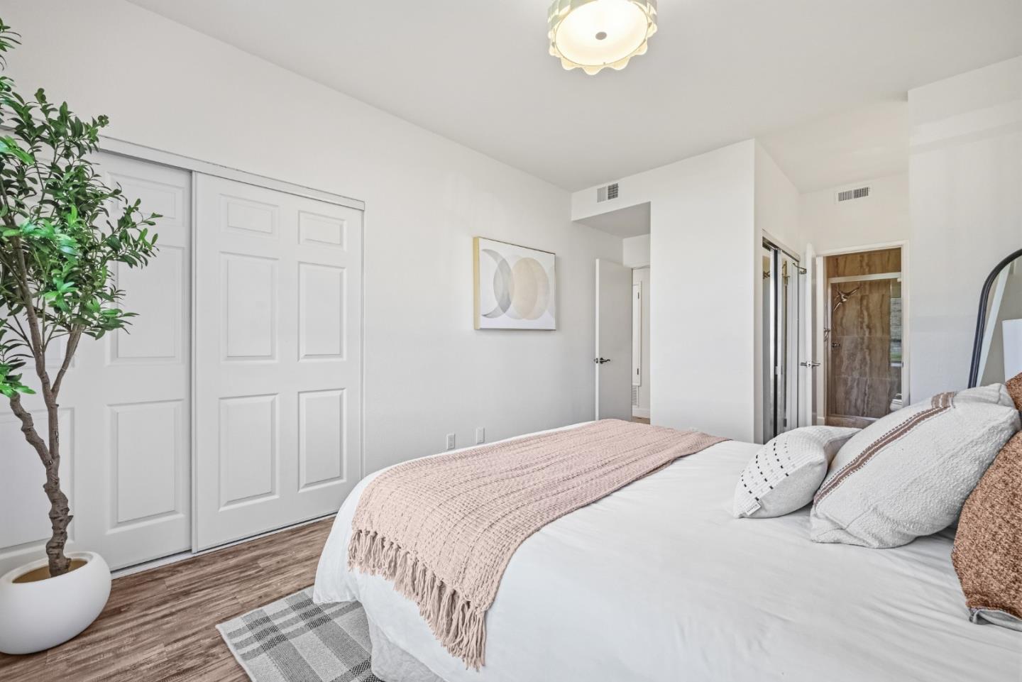 34590 Falls Terrace Fremont, CA 94555 - Photo 19 of 38 a bedroom with a bed and a potted plant