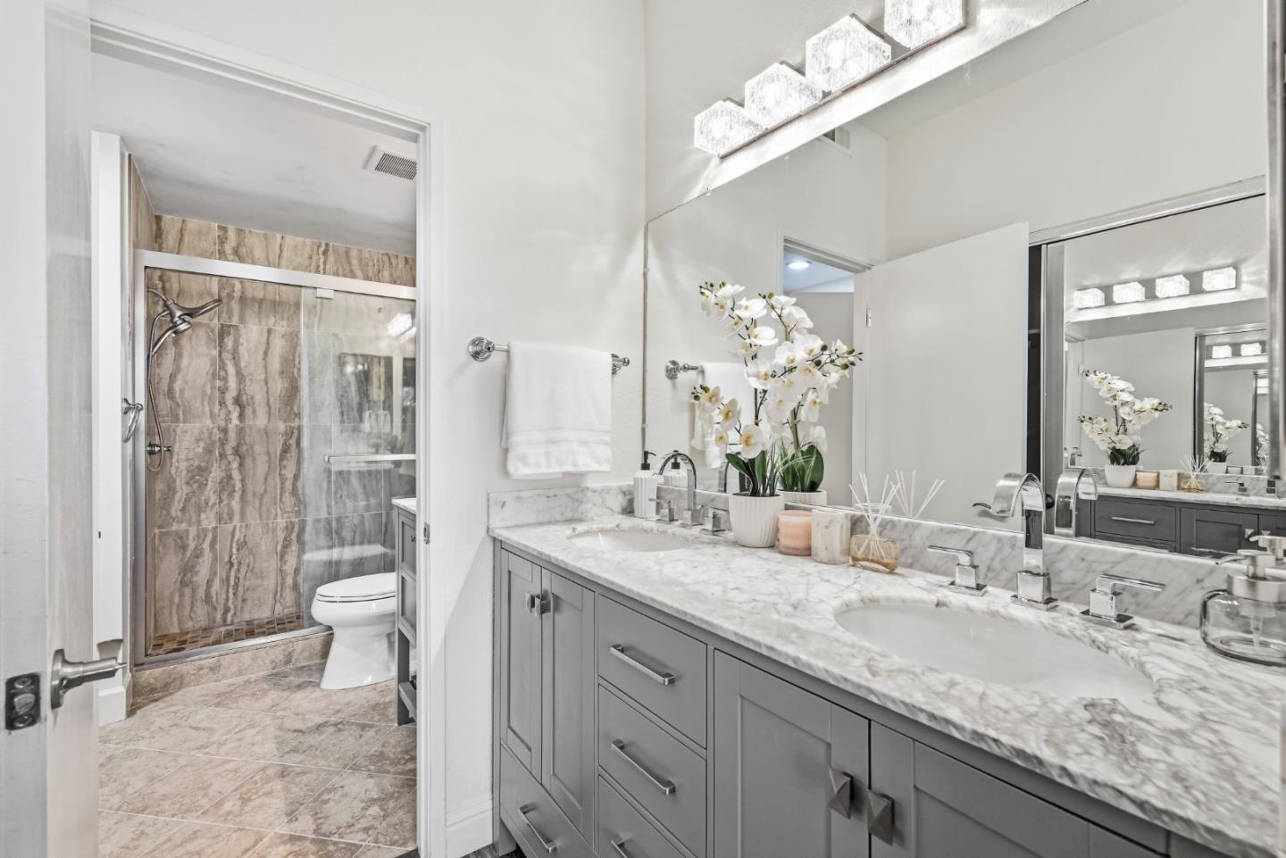 34590 Falls Terrace Fremont, CA 94555 - Photo 21 of 38 a bathroom with a granite countertop sink a toilet a mirror and shower