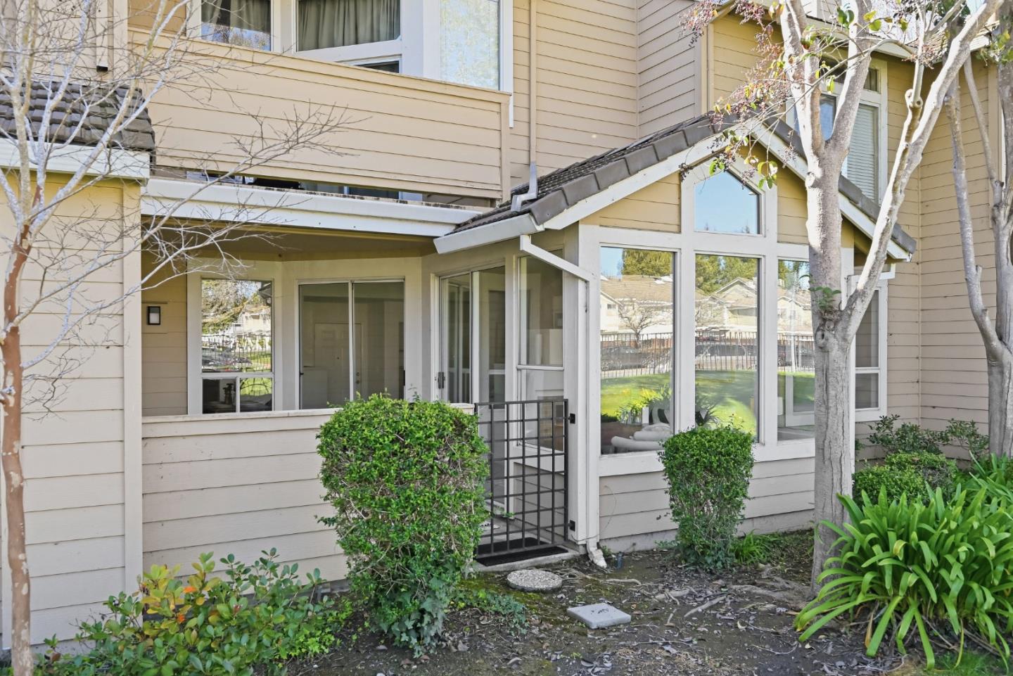 34590 Falls Terrace Fremont, CA 94555 - Photo 27 of 38 a view of a house with large windows and plants