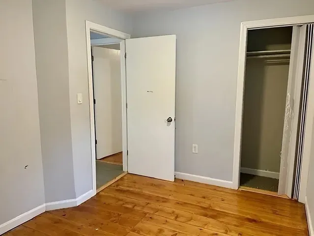 a bathroom with a granite countertop sink a mirror and shower