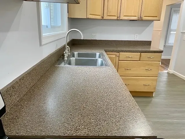 a kitchen with a sink and cabinets