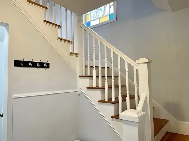 a view of entryway with staircase and wooden floor