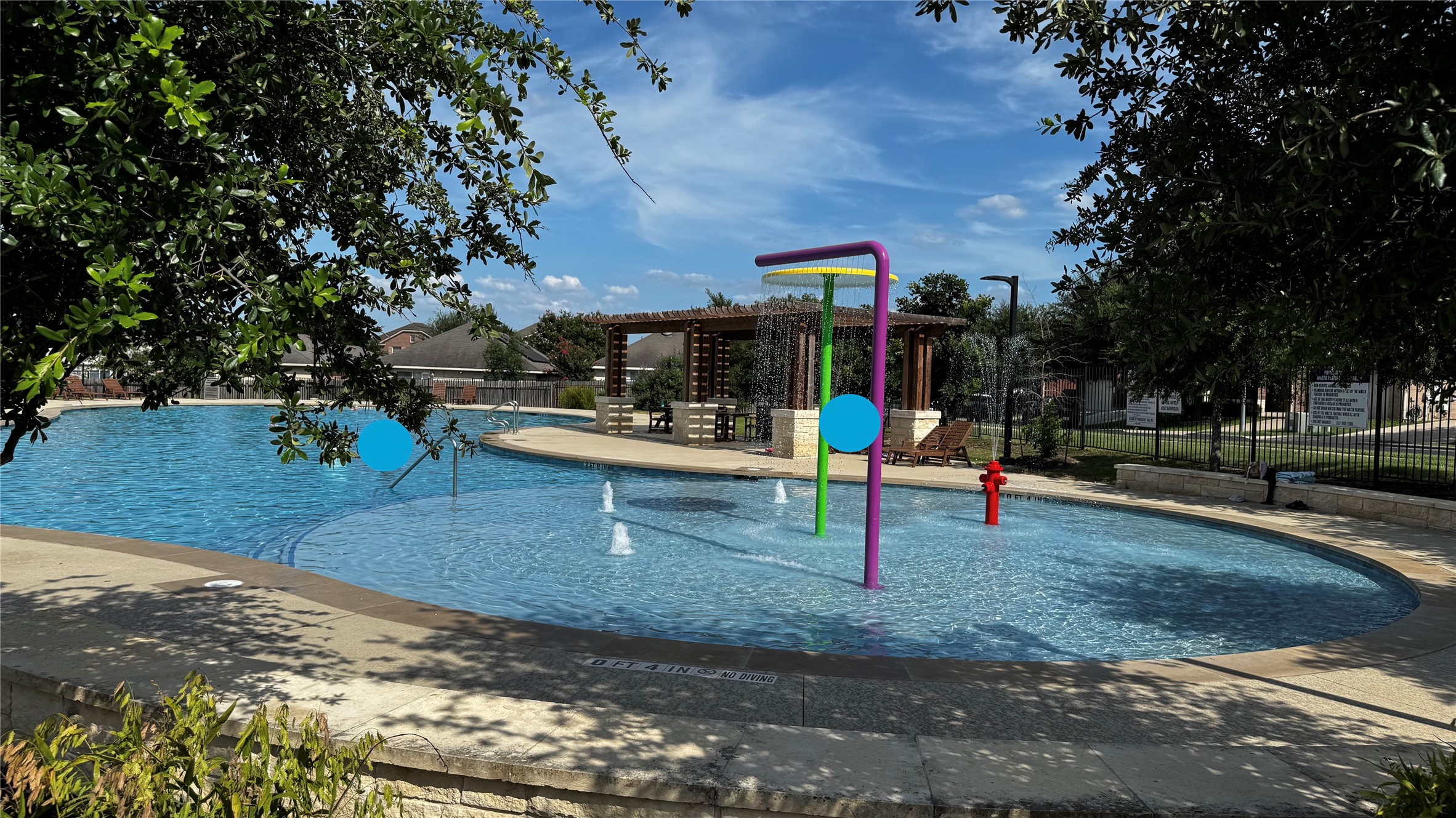 14008 Levy Pflugerville, TX 78660 - Photo 15 of 15 An inviting community pool with playful water features and a shaded pergola for relaxation.