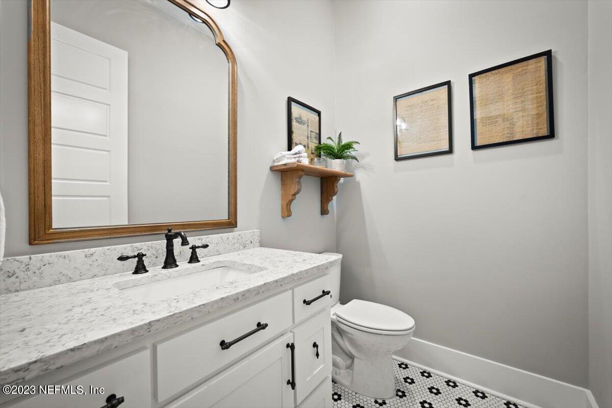 3200 Jane Lane Hilliard, FL 32046 - Photo 20 of 72 a bathroom with a granite countertop toilet sink and mirror