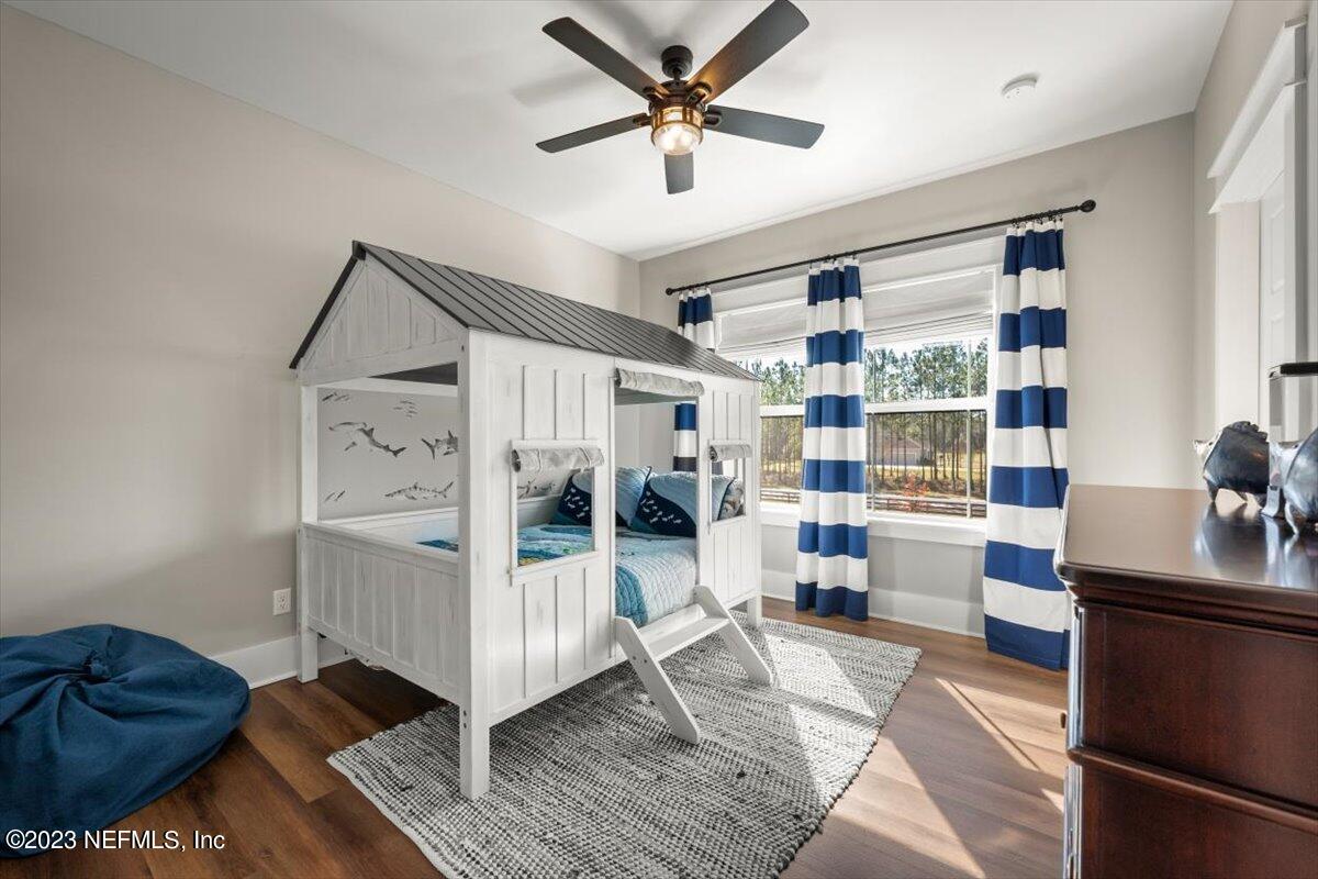 3200 Jane Lane Hilliard, FL 32046 - Photo 31 of 72 a living room with furniture and a chandelier