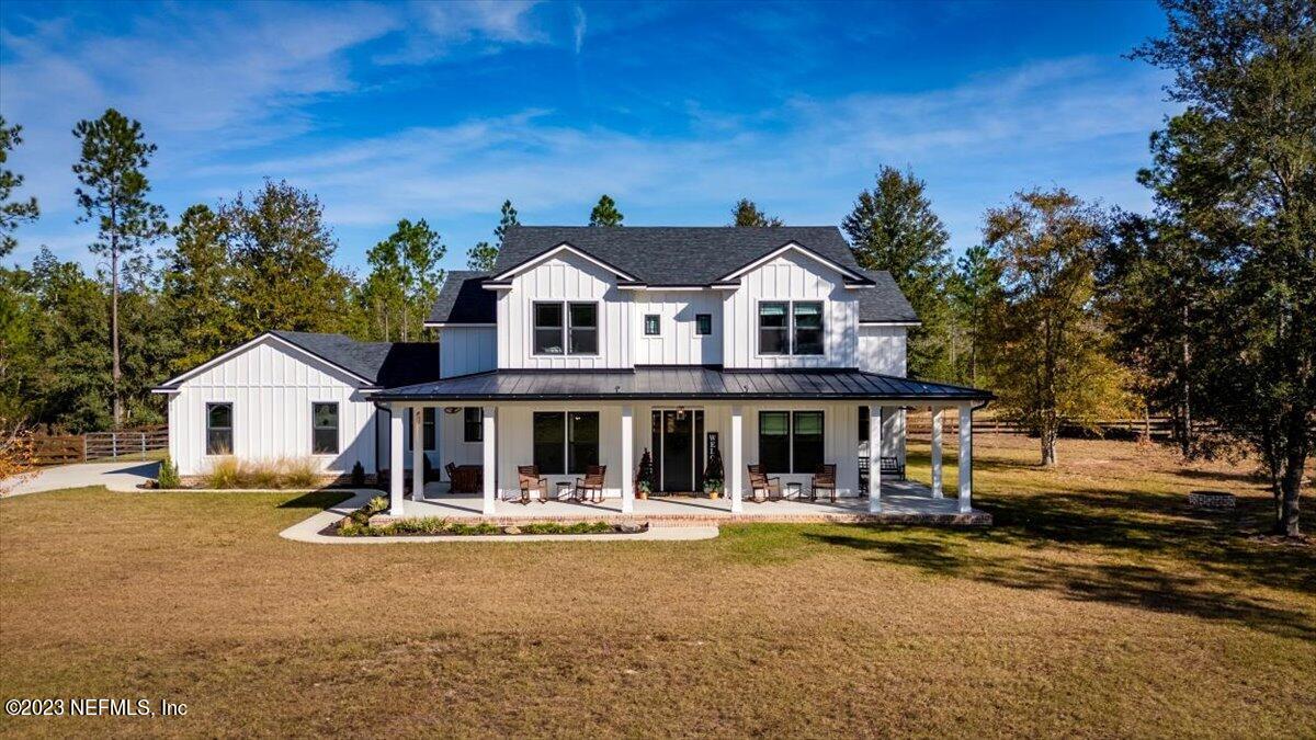 3200 Jane Lane Hilliard, FL 32046 - Photo 47 of 72 a front view of a house with a yard patio and swimming pool