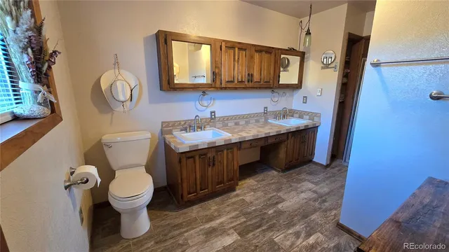 a bathroom with a toilet sink and mirror