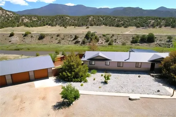 an aerial view of a house with a yard and lake view