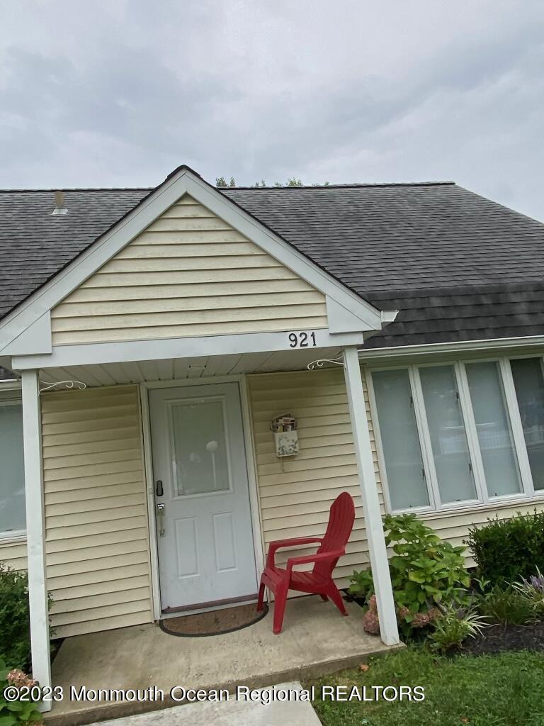a view of a house with a small yard and potted plants